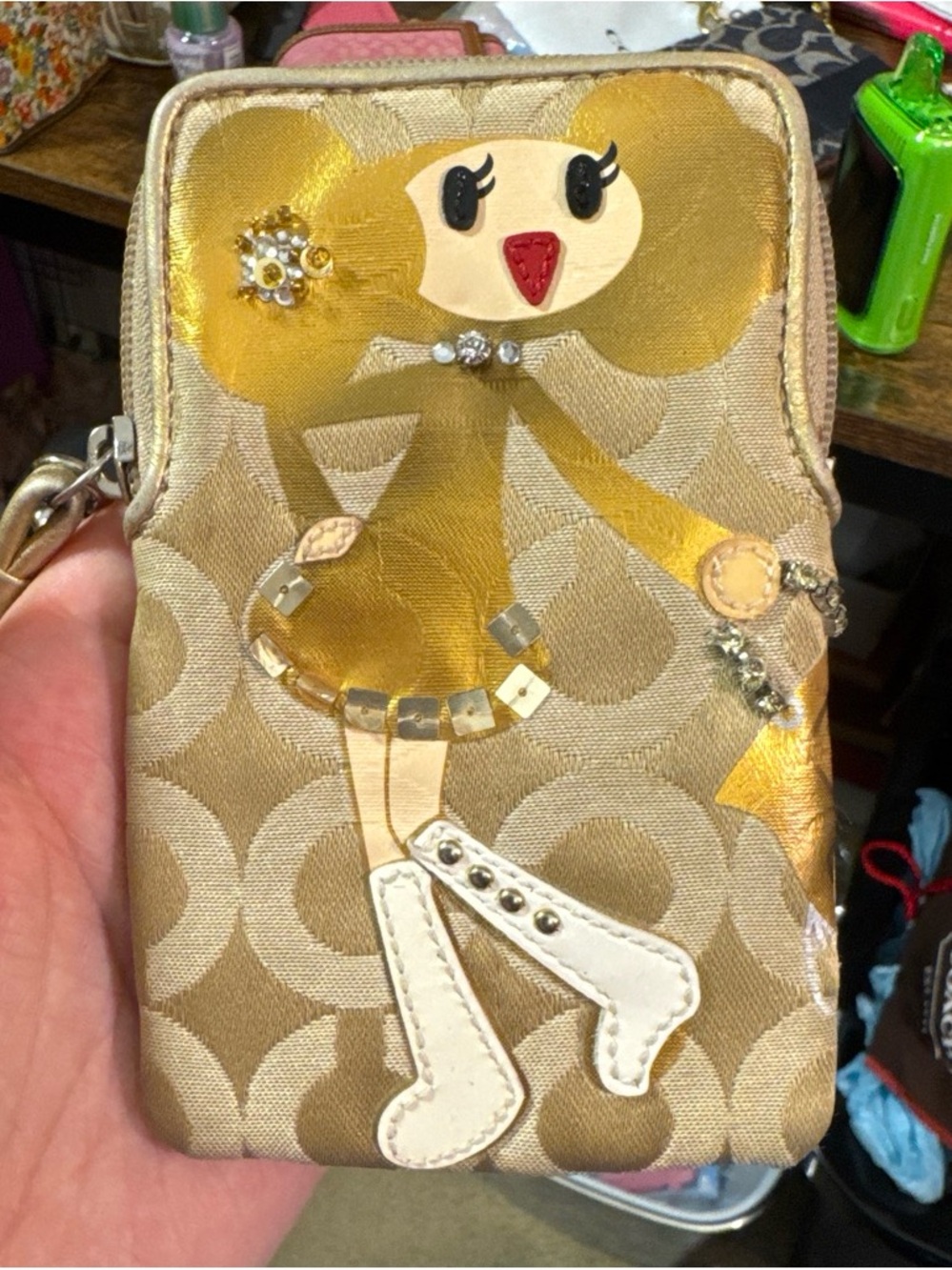 Coach Metallic Gold Signature Phone Wristlet with Doll Appliqué